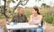 Man and woman communicate sitting at the table in their garden