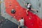 Man and woman competing at rock climbing wall.