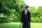 A man and woman couple dressed in black graduation gown or graduates with congratulations with graduation hats is standing