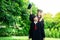 A man and woman couple dressed in black graduation gown or graduates with congratulations with graduation hats is standing,