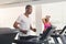Man and woman, couple in gym on treadmills