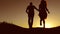 Man and woman couple in love silhouette jumping in slow motion video. Man and woman joy running and jumping on nature