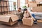 Man and woman couple packing fragile cardboard box at new home