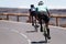 Man and woman couple road cycling on race bike