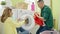 Man and woman couple sitting on floor together smelling dirty clothes at laundry room