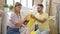 Man and woman couple smelling dirty clothes at laundry room