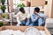 Man and woman couple tired sitting on floor at new home