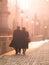 Man and woman couple walk on Charles Bridge in foggy morning, Prague, Czech Republic. Romantic Prague theme