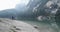 man and woman couple walking near Braies lake in cloudy day. Group of friends summer adventure journey in mountain
