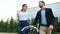 Man and woman coworkers walking from work with bike and to go coffee talking