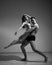 A man and a woman are dancing modern ballet. Acrobatic couple perform number on a white background. A duet of gymnasts