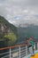 Man and woman on deck of cruise liner in fjord. Hellesylt, Geiranger, Stranda, Norway