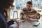 Man with woman discussing over chart in cafe