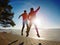 Man and woman do sports at lake against strong morning Sun