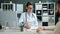 Man and woman doctor and patient talking in hospital then shaking hands smiling