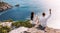 A man and a woman drink champagne on the seashore, rear view. Wedding trip to the sea, panorama. A couple in love