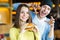 Man and woman eating burger. Young girl and young man are holding burgers on hands