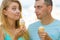 Man and woman eating ice cream on beach