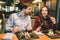 Man and woman are eating at the table in restaurant and talking to each other. They are enjoying company of one another.