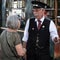 Man and woman are engaged in a conversation while standing in a train station