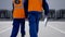 Man and woman in engineer uniform walk towards loading docks