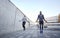 Man and woman exercising with jump-rope outdoors