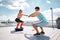 Man and woman are exercising together on rooftop