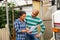 Man and woman farmers talking near car