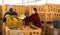 Man and woman farmers talking during stacking pumpkins