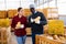 Man and woman farmers talking during stacking pumpkins