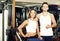 Man and woman fitness coaches in gym