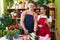 Man and woman florists cutting flowers at flower shop