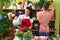 Man and woman florists watering plant working at flower shop