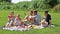 man and woman with four kids on picnic together