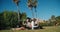 Man and woman freelance workers sitting in park with laptop and tablet outdoors