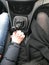 Man and woman, girl, couple in love hold with hands clasped with handsome manicure in a car with a mechanical six-speed gearbox
