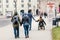 Man with a woman goes by the hand through the streets of Vienna against the background of another couple in love in a wheelchair