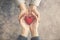 Man and woman hands together with red heart