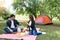 Man and woman happy drink in front of camping tent