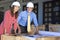 Man & Woman In Hard Hats on Construction Site