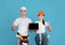 Man And Woman In Hardhats Holding Laptop With Black Screen, Mockup Image