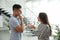 Man and woman having conversation in hall