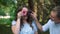 Man and Woman Having Fun with Donuts in Park