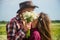 man and woman having romantic date in poppy flower field with guitar music and wine, love