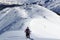 Man and woman hiking on snowshoes and mountain snow panorama in Stubai Alps