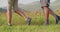 Man and woman hiking using trekking poles.Nordic walking outdoor on a trail path near flower fields in Castelluccio di