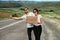 A man and a woman are hitchhiking. A young couple goes hitchhiking around the country. Free hitchhiking trip. A lover who travels