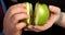 Man and woman hold in hands with halves apple