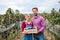 Man and woman holding grapes in box in vineyard in autumn, harvest concept.