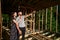 Man and woman inspecting their future wooden frame house nestled in the mountains near forest.